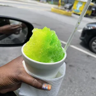 a person holding a cup of ice cream