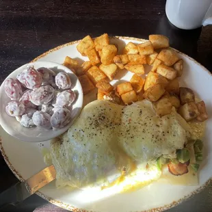 Eggs Benedict with home fries and grape salad!