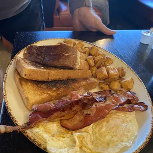 Eggs, bacon , toast and potatoes