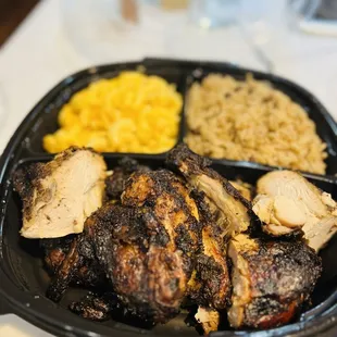 Jerk chicken dinner with rice and peas and Mac and cheese