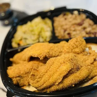 Fried catfish dinner with red beans and rice and cabbage