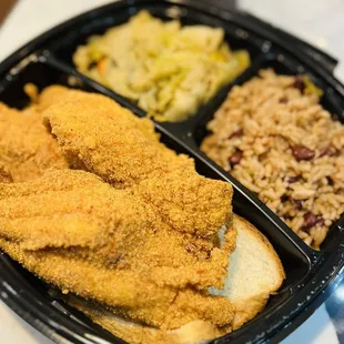 Fried catfish dinner with red beans and rice and cabbage