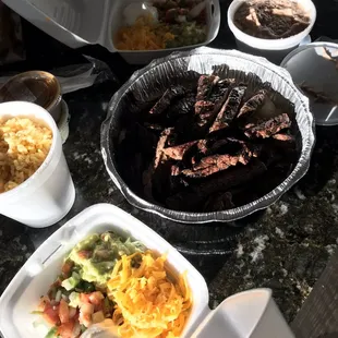 Steak fajita meat, rice, refried beans, guacamole, and salsa!