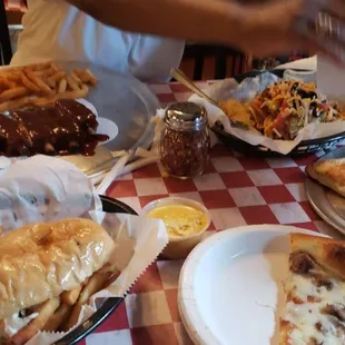 Steak and ranch pizza, nacho grande ribs and corned beef sandwich topped with fries and coleslaw