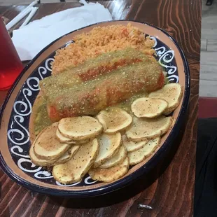 Spinach avocado enchiladas in tomatillos sauce with potatoes and rice.