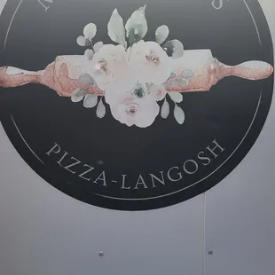 a woman holding a pizza