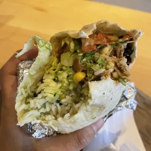 a hand holding a burrito