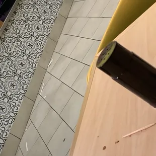 The floor in front of the counter.