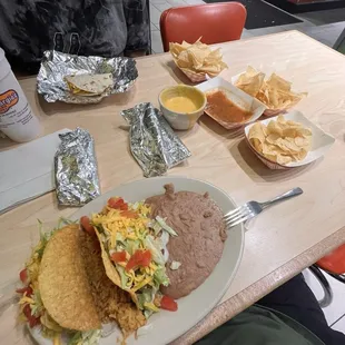 Crispy taco plate, chips and queso with bean and cheese tacos
