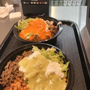 two bowls of food on a tray