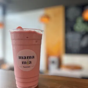 a pink smoothie in a plastic cup