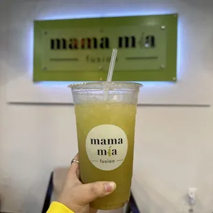 a person holding a cup of juice