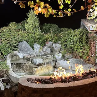 a fire pit with a waterfall
