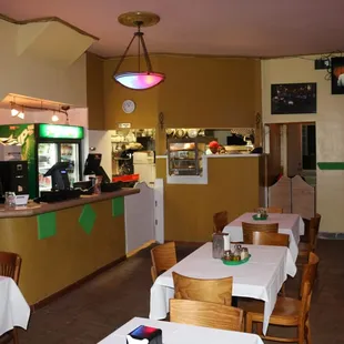 a dining area with tables and chairs