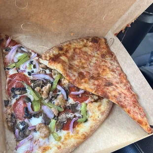 two slices of pizza in a box