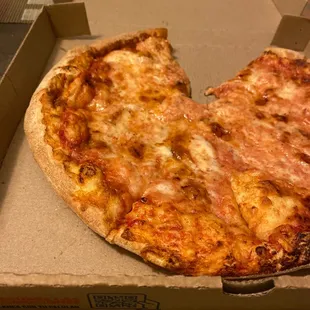 a half eaten pizza in a box