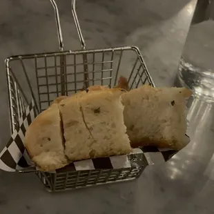 a basket of bread and a glass of water