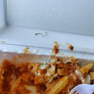 a plastic container with pasta and cheese