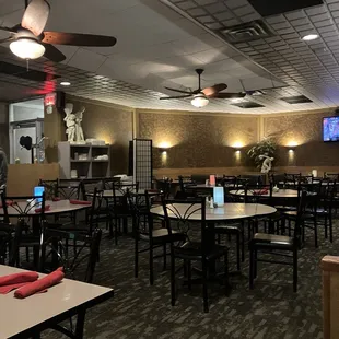 a dining area with tables and chairs