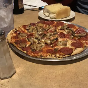 Thin crust pepperoni and mushroom pizza