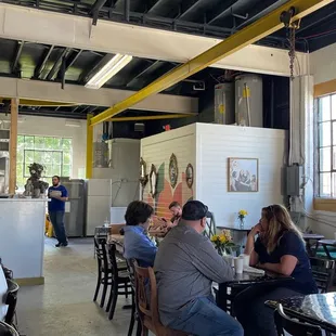 a group of people sitting at tables in a restaurant