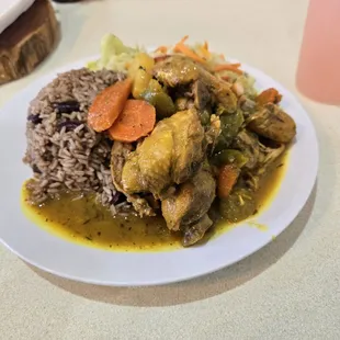 Curry combo plate with cabbage and rice and beans.