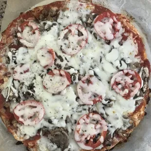 a pizza with mushrooms, mushrooms, and cheese