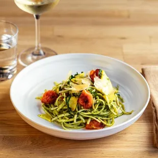 a plate of pasta and a glass of wine