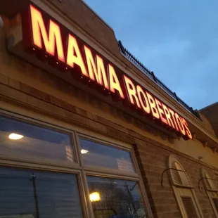 a neon sign on the outside of a restaurant