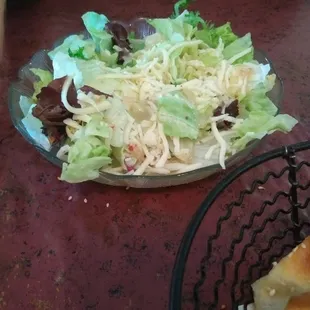 a plate of salad and a sandwich