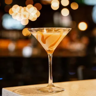 a martini with a lemon slice in it