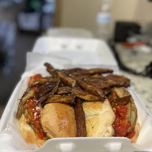 a hot dog with onions and tomato sauce