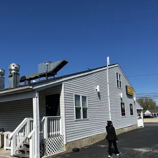 a woman walking in front of a restaurant