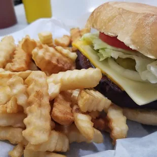 Thick-cut fried bologna sandwich with everything, plus a side of French fries.