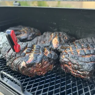 steaks cooking on a grill
