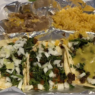 A taco plate with delectable rice and beans. Get the al pastor!