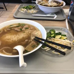 Pho with steak and meatballs for me. Signature pho across the table.