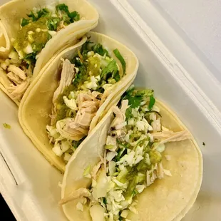 three tacos in a styrofoam container