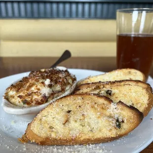 a plate of toasted bread and a glass of beer