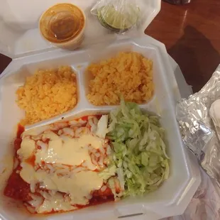 Chicken enchilada plate (all rice no beans) with 2 asada tacos wrapped up staying warm on the side.