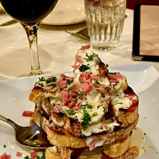 a plate of french toast and a glass of red wine