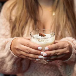 a woman holding a glass of milk