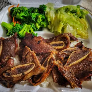 a plate of meat and broccoli
