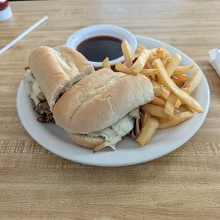 Philly sandwich and french fries. Au jus on the side.
