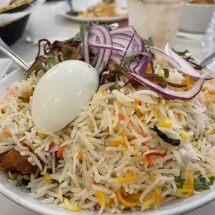 a bowl of rice with an egg on top
