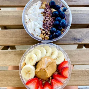 two bowls of fruit and yogurt