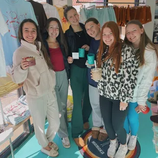 a group of women holding cups of coffee