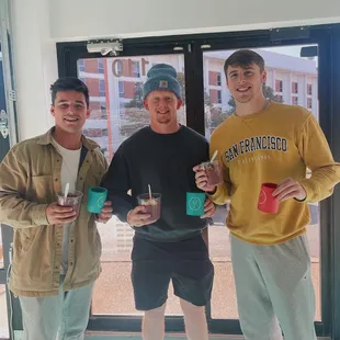 three men holding their cups