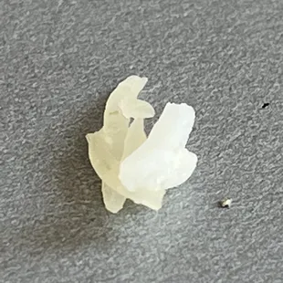 Hard and dried up pieces of rice mixed in with cooked rice.
