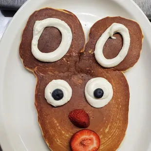 a plate of pancakes decorated like a reindeer